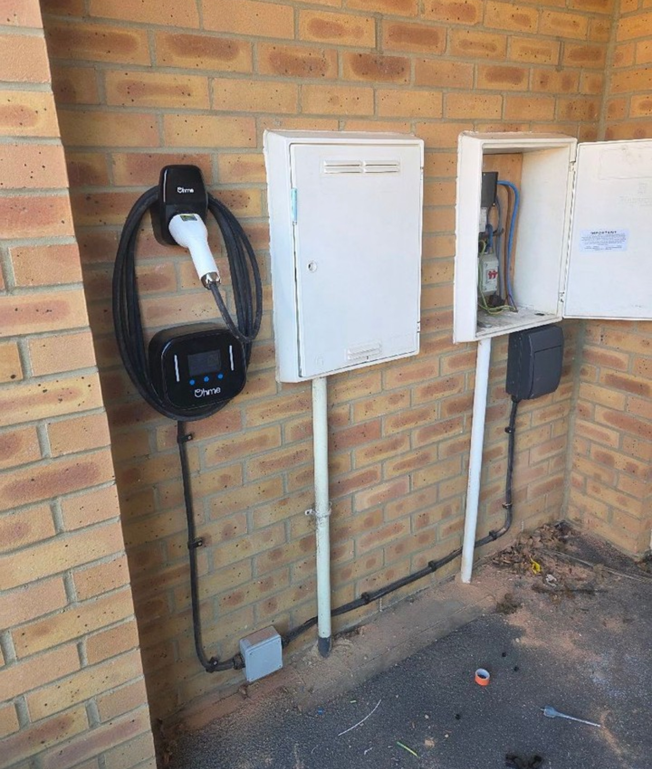 Ohme EV charger installed next to the property's electrical equipment
